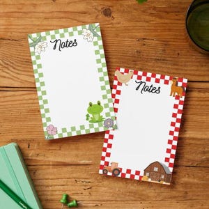 May include: Two rectangular note pads with white centers and the word Notes printed at the top. One pad features a green and white checkered border with illustrations of a frog and flowers. The other has a red and white checkered border with a chicken, horse, tractor, and barn.