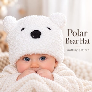May include: A white fuzzy knit hat featuring two small bear ears on top and a black embroidered nose and eyes. The text Polar Bear Hat knitting pattern is printed on the right side of the image. The hat is worn over a light-colored textured blanket.