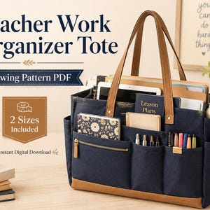 May include: A navy blue canvas tote bag with tan leather-like trim, featuring multiple exterior pockets, two long shoulder straps, and a zippered front compartment. The bag is filled with notebooks, a tablet, and pens, with text reading Teacher Work Organizer Tote.