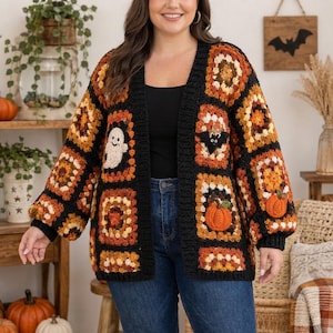 May include: A long-sleeve open-front cardigan made of black, orange, and brown crochet granny squares. The garment features appliqued motifs including a white ghost, a black bat, and orange pumpkins, finished with a solid black ribbed trim.