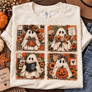 May include: A cream-colored t-shirt featuring four square panels with ghost illustrations. The ghosts are decorated with pumpkins, sunflowers, books, and bows. One panel includes the text 'SPOOKY BUT CUTE' and another 'GOOD BOOKS SPOOKY MOODS'.