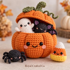 May include: A crocheted orange pumpkin container with a lid, featuring a smiling face, holding a small white ghost and a black bat. Beside it sits a black spider and a yellow, orange, and white candy corn, all with faces. Text reads Royal Crafted Co.
