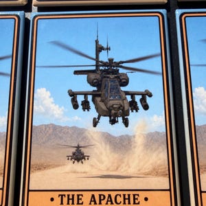 May include: A rectangular magnet featuring a graphic of two military Apache helicopters flying over a desert landscape with dust clouds. The image is framed by a tan and black border, with the text THE APACHE printed in black at the bottom.