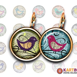 May include: A pair of round, gold-toned earrings with a bird design. One earring features a purple bird with a yellow belly on a green background, the other a pink bird on a blue background. Additional bird designs in various colors are in the background.