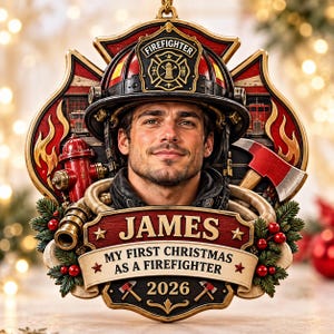 May include: A decorative Christmas ornament featuring a firefighter wearing a helmet, surrounded by a fire hydrant, an axe, and fire imagery. The ornament includes the name JAMES, the text MY FIRST CHRISTMAS AS A FIREFIGHTER, and the year 2026.