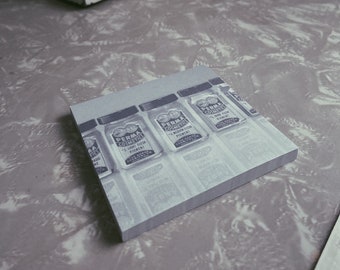 May include: A close-up of a stack of small glass jars with labels that read "Perma Cosmetics - 1 oz Liquid Flesh Pigment". The jars are arranged in a row on a white surface.