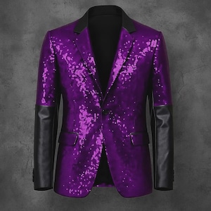 May include: A purple blazer featuring a sequined body with a gradient effect, solid black lapels, and solid black sleeves. The garment includes a single-button front closure and two side flap pockets, showcasing a distinct contrast between the textured sequin fabric and the smooth black material on the sleeves and collar.