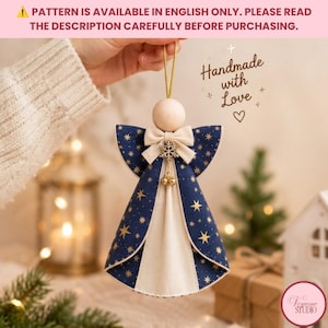 May include: A hanging angel ornament featuring a smooth wooden bead head, a cream-colored fabric bow, and a gold snowflake charm with two small bells. The body is made of navy blue fabric with gold star patterns and a cream-colored center panel.