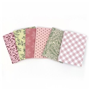 May include: Six small paper pads with different patterns. The patterns include a pink and brown damask, a green and white floral, a pink and white polka dot, a pink and white gingham, and a pink and white floral.