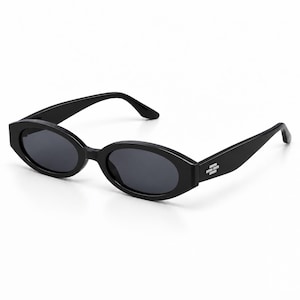May include: Black sunglasses featuring oval-shaped frames and dark tinted lenses. The temples are wide and include a small, silver-toned rectangular emblem on the side near the hinge, providing a distinct detail to the solid black construction.