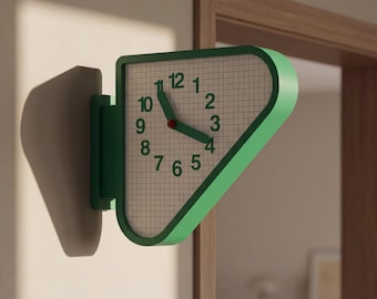 May include: A wall-mounted clock with a green, triangular frame and rounded corners. The clock face features a white grid pattern background with green numerals from 1 to 12. It has two green hands and a small red center point indicating the time.