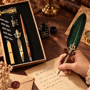 May include: A calligraphy set featuring a dark green feather quill pen with a gold metal accent, a wooden pen, a gold letter opener, a wax seal stamp, five metal nibs, and a bottle of black ink, all housed in a rectangular box.