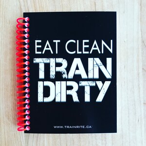 May include: Black spiral bound notebook with the text "Eat Clean Train Dirty" in white letters. The bottom of the notebook has the website "www.trainrite.ca" printed in white.