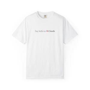 May include: A white short-sleeve t-shirt with a crew neckline. The center of the chest features the text 'Say hello to' in dark gray, followed by a small orange sun icon and the word 'Claude' in dark gray. The shirt has a standard fit.