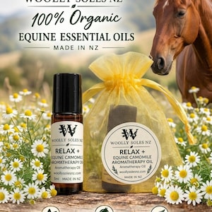 May include: A 5ml amber glass roller bottle and a yellow organza drawstring bag containing equine essential oil. The labels read WOOLLY SOLES NZ, 100% Organic, RELAX + EQUINE CAMOMILE AROMATHERAPY OIL, and Made in NZ. The product is displayed with chamomile flowers.