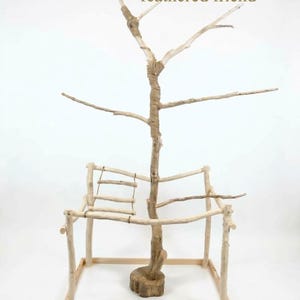 May include: A light-colored wooden bird play stand featuring a central branch structure wrapped in twine, a square base, and a small hanging ladder. The text "Bring a gift for your feathered friend" is printed at the top of the image.