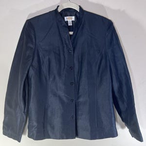 May include: A dark blue blazer with a mandarin collar and button closure. The blazer has long sleeves and a fitted silhouette.