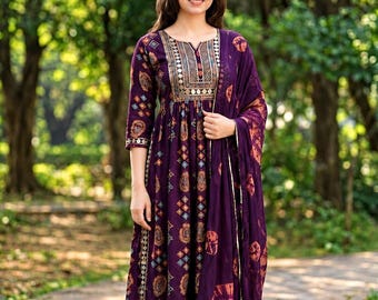 May include: A deep purple knee-length dress featuring a geometric and circular print, a notched neckline with metallic embroidery, three-quarter sleeves, and a matching purple dupatta with a tie-dye pattern, paired with solid purple leggings.