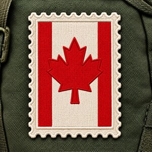 May include: A rectangular embroidered patch shaped like a postage stamp featuring the Canadian flag. The design displays a central red maple leaf on a white background flanked by two vertical red bars, all bordered by a scalloped edge.