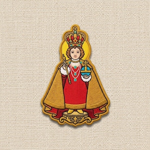 May include: An embroidered patch depicting a figure wearing a red robe, a gold cape, and a crown. The figure holds a gold scepter and a blue orb with a cross. The design features intricate gold, red, and blue thread work on a textured fabric.
