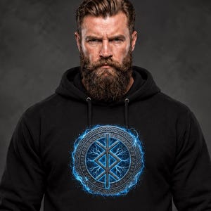 May include: A black hooded sweatshirt featuring a central circular graphic. The design displays a blue glowing runic symbol surrounded by intricate knotwork patterns and electric blue lightning effects on the chest area.