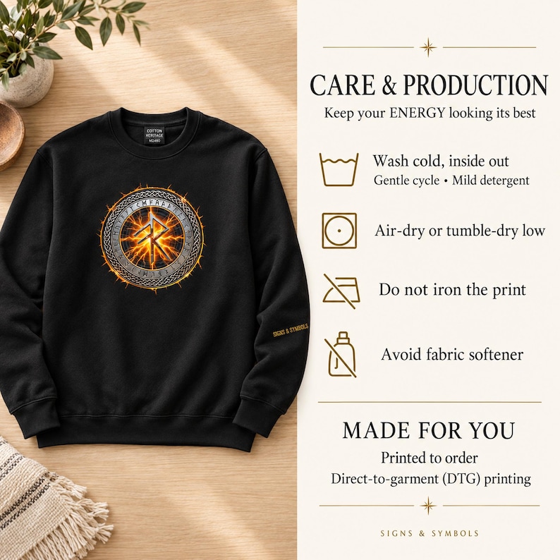 May include: A black crewneck sweatshirt featuring a circular graphic with a glowing orange rune symbol surrounded by a metallic border. The text CARE & PRODUCTION, MADE FOR YOU, and care instructions are printed on the right side of the image.