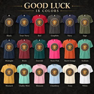 May include: A collection of eighteen short-sleeved t-shirts in various colors, including black, navy, red, graphite, sage, midnight, brick, emerald, neon pink, burnt orange, seafoam, mustard, mint, blossom, chambray, ivory, and white, each with a graphic.