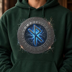 May include: A dark forest green hooded sweatshirt featuring a central circular graphic. The design displays a metallic ring inscribed with runic characters surrounding a glowing blue lightning bolt symbol shaped like a stylized letter R.