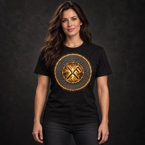 May include: A black short-sleeved t-shirt featuring a circular graphic on the chest. The design includes a glowing orange ring with intricate knotwork patterns and runic symbols surrounding a central golden rune symbol on a dark background.