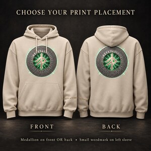 May include: A beige hooded sweatshirt featuring a circular medallion with a central rune symbol surrounded by a green glowing energy effect and a runic border. The text CHOOSE YOUR PRINT PLACEMENT, FRONT, BACK, and SIGNS & SYMBOLS are visible.