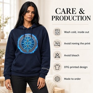 May include: A navy blue hooded sweatshirt featuring a central circular graphic with a blue glowing runic symbol and lightning effects. The text CARE & PRODUCTION lists instructions: Wash cold, inside out, Avoid ironing the print, Avoid bleach, DTG printed design, and Made to order.