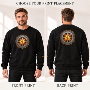 May include: A black long-sleeve sweatshirt featuring a circular graphic with a glowing orange fire effect and a central rune symbol. The design is displayed on the chest in one view and on the back in another, with the text CHOOSE YOUR PRINT PLACEMENT.
