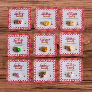 May include: Nine square cards labelled Meet your Savings Buddy, each featuring a small food-themed magnet. The magnets include a peppermint, pretzel, toast, tree, cookie, croissant, ice cream, popsicle, and cupcake, all on pink and orange backgrounds.