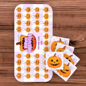 May include: A rectangular Halloween savings challenge card with a light purple and white checkered pattern, featuring rows of small orange jack-o'-lantern icons and circles. It includes a large pumpkin graphic with the text Happy Halloween and Pick Card & Save £100, alongside several smaller square cards showing individual pumpkins and currency values.