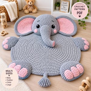 May include: A circular crochet rug shaped like an elephant with a gray body, large pink-lined ears, and pink accents on the feet. The elephant features a trunk, black eyes, and a small tail with a tassel. Text on the image reads CROCHET PATTERN PDF.