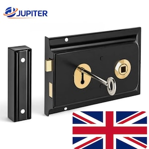 May include: A black rim lock with a rectangular body and a separate matching strike plate. The lock features a gold-coloured keyhole escutcheon with a silver key inserted, a gold-coloured square spindle hole, and two protruding brass-toned bolts.