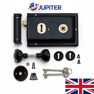 May include: A black rim lock set featuring a rectangular lock body with brass keyhole and spindle inserts, a matching strike plate, two black round knobs, two circular escutcheons, two silver keys, and various mounting screws for installation.