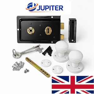 May include: A black rim lock set with a brass keyhole and square spindle hole, two white round door knobs, a strike plate, two skeleton keys on a ring, a brass spindle, and various mounting screws, all branded with the JUPITER logo.