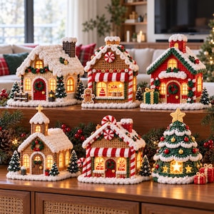 May include: A collection of six crocheted Christmas decorations including four houses, a church, and a tree. Each piece features intricate yarn textures, white snow-like trim, and warm internal lighting. The set includes a gingerbread man figure.