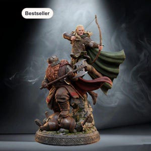 May include: A detailed figurine featuring a blonde archer in a green cloak aiming a bow and a bearded warrior in brown armor wielding a double-headed axe. Both figures stand on a rocky base. The image includes a label with the text Bestseller.