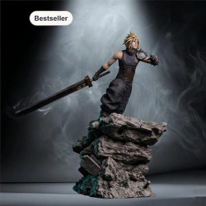 May include: A detailed figurine of a spiky-haired character standing on a rocky base, holding a large, long, dark sword. The character wears a dark sleeveless top, dark trousers, and a shoulder pauldron. A white label with the text Bestseller is visible.