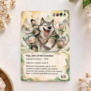 May include: A Magic: The Gathering trading card titled Voja, Jaws of the Conclave, featuring a large, smiling gray wolf surrounded by small elf figures in a watercolor-style landscape. The card text details creature abilities and stats.