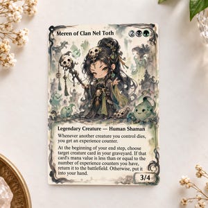 May include: A Meren of Clan Nel Toth trading card featuring a chibi-style human shaman character with long dark hair, a skull headpiece, and a staff. The card includes text detailing the legendary creature's abilities, mana cost, and 3/4 power and toughness stats.