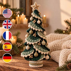 May include: A decorative tabletop Christmas tree crafted from dark green and sage green crochet yarn. The tree features layered, scalloped branches trimmed with cream-colored yarn, adorned with small gold beads and cream crochet ornaments.