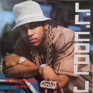 May include: Album cover featuring a man wearing a gray bucket hat, gold chain, and a watch. The album title reads "I'M THAT TYPE OF GUY" with "extended version" and "Rock the Bells" below. The artist's name, "LL COOL J", is displayed vertically.