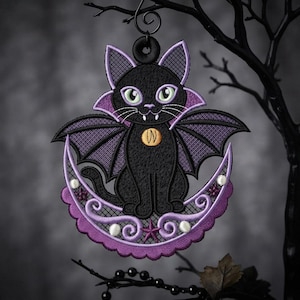 May include: An embroidered hanging ornament featuring a black cat with purple bat wings and a collar with a gold circular emblem. The cat sits on a purple crescent moon decorated with small white spheres and a star, finished with a black hanging loop.