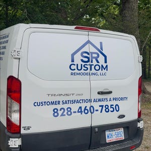 May include: A white Ford Transit 250 cargo van with blue lettering and a house-shaped logo. The text reads SR CUSTOM REMODELING, LLC, CUSTOM SATISFACTION ALWAYS A PRIORITY, and the phone number 828-460-7850. It features a North Carolina license plate WAK-5892.