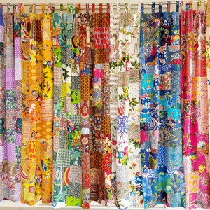 May include: A set of colorful patchwork curtains with a variety of floral and geometric patterns. The curtains are made from different fabrics and sewn together in a random pattern.