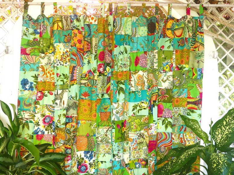 May include: A pair of green and turquoise patchwork curtains with a floral and geometric pattern. The curtains are made of different fabrics sewn together in a grid pattern.