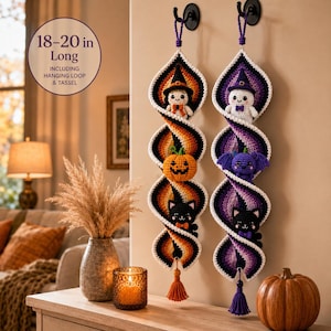 May include: Two vertical crochet spiral wall hangings, 18-20 inches long including hanging loop and tassel. The left features a witch, pumpkin, and black cat. The right features a ghost, bat, and black cat, with orange-yellow and purple color schemes.